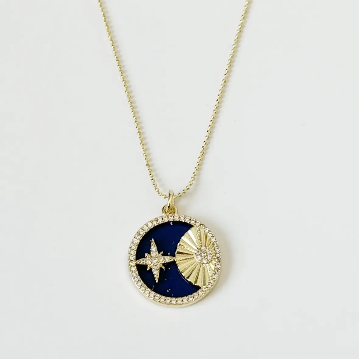 Necklace with a blue and gold pendant on a white background