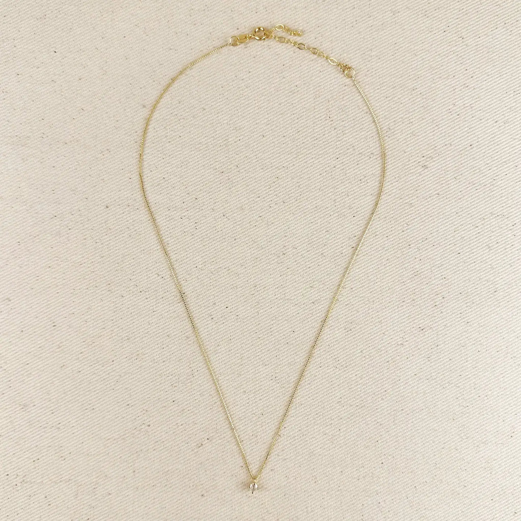 Gold necklace on a beige background