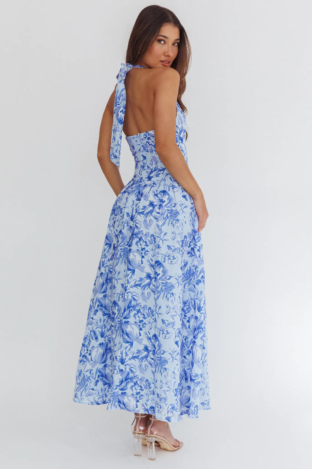 Woman wearing a blue floral dress on a white background