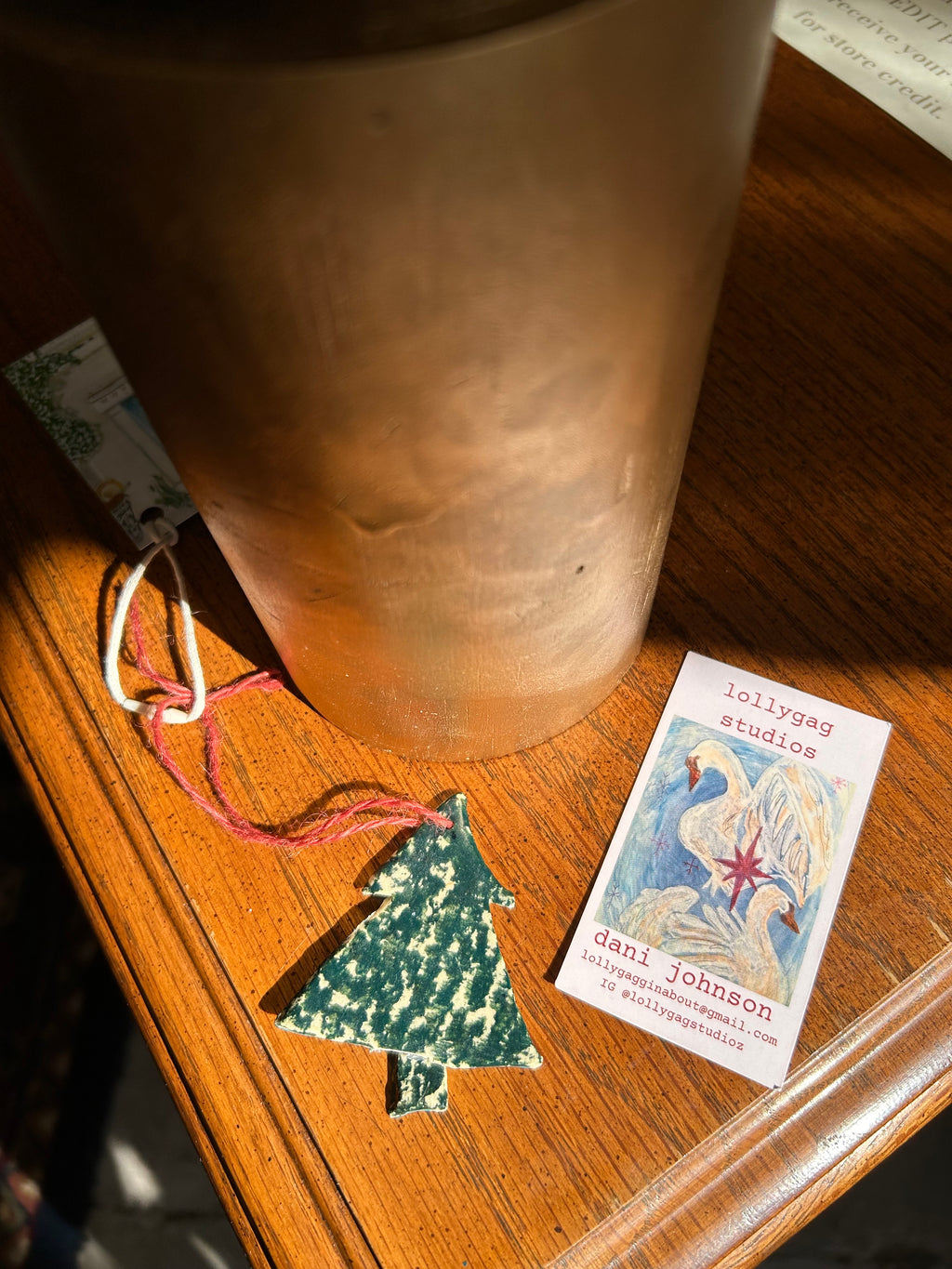 Wooden surface with a decorative item and a small card.