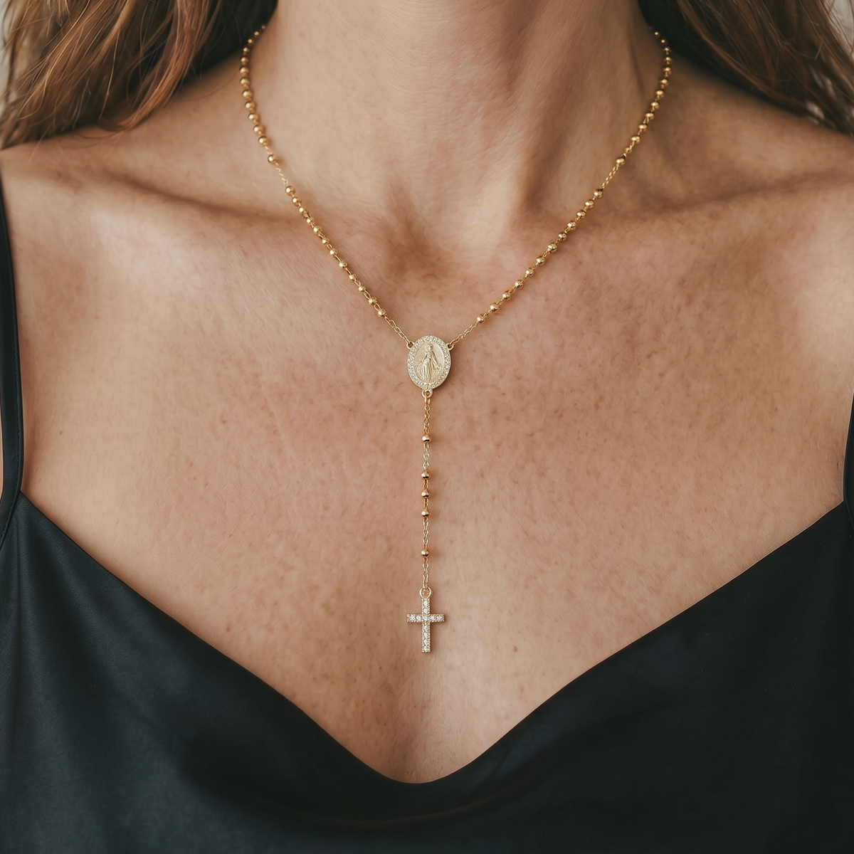 Woman wearing a gold necklace with a cross pendant