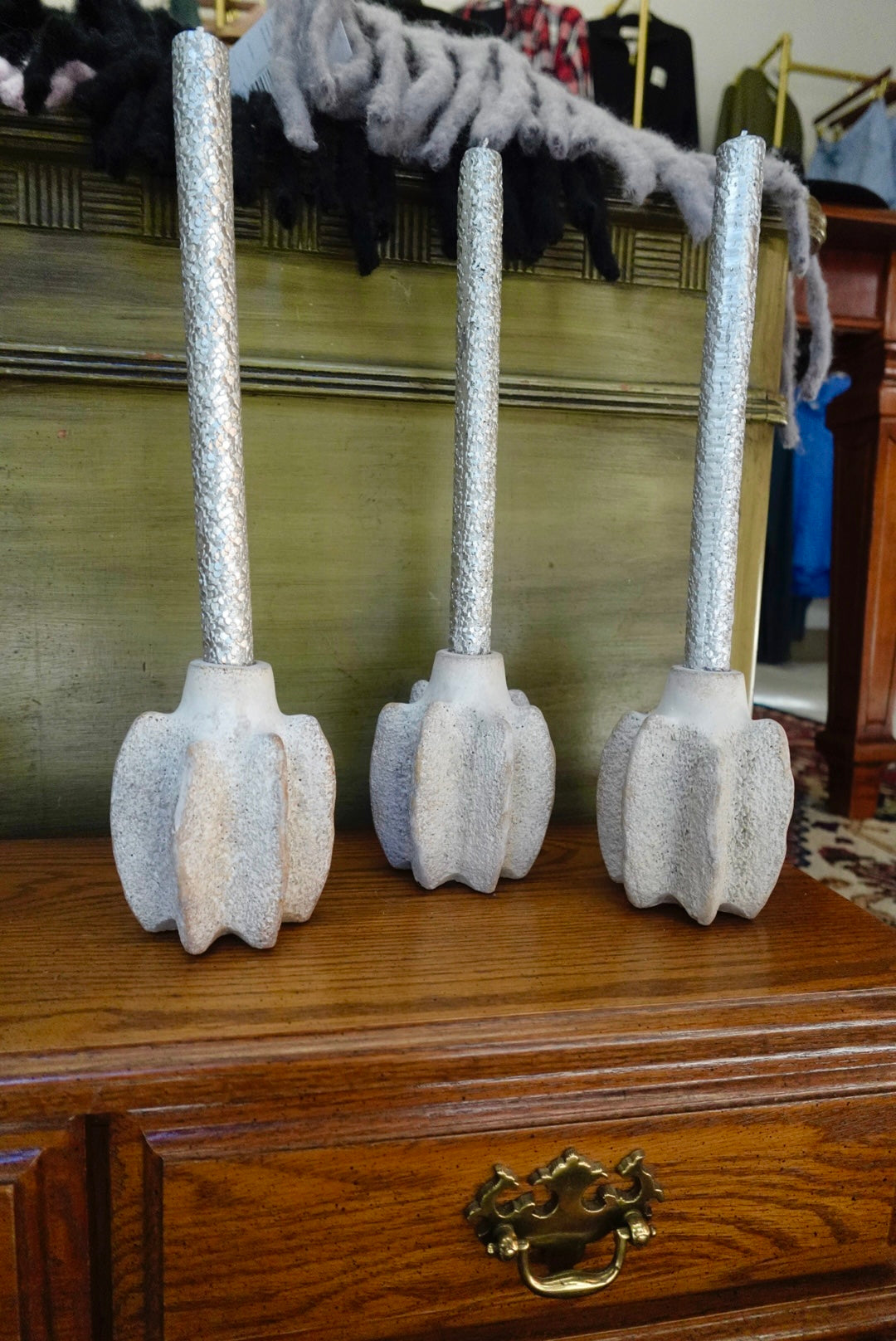 Decorative broomsticks with fluffy ends on a wooden surface