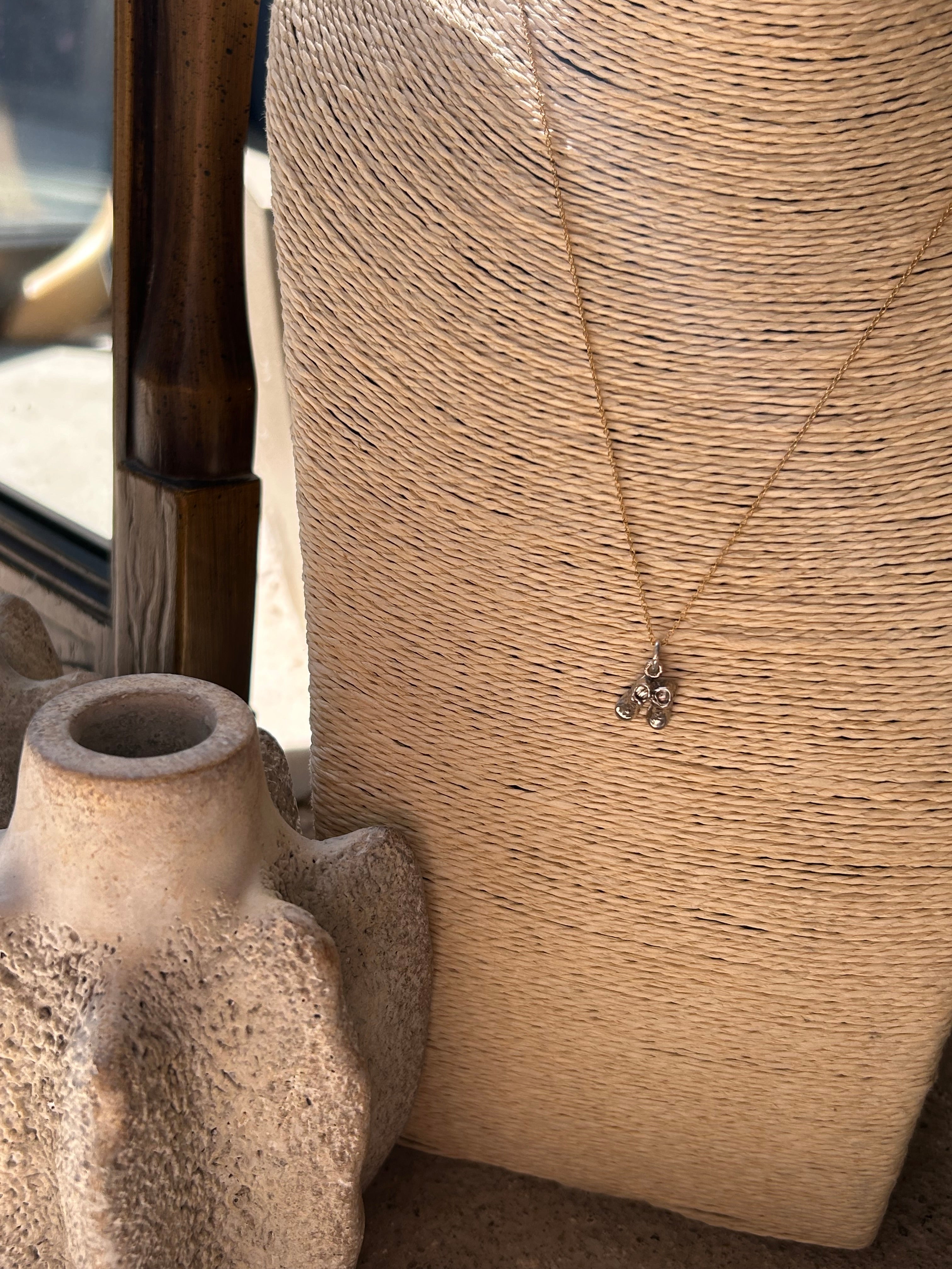 Close-up of a textured surface with a pipe and a small object on it