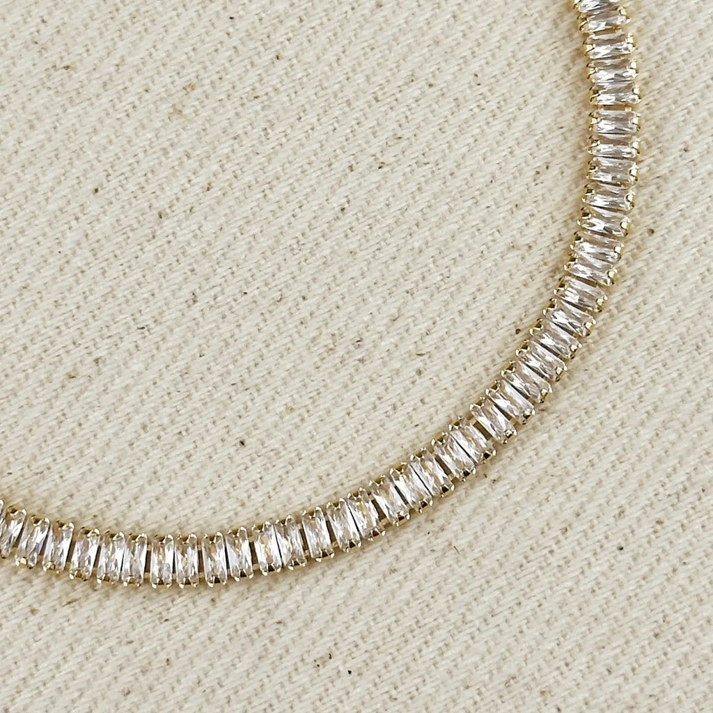 Diamond necklace on a textured beige surface