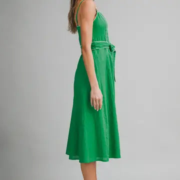 Green dress worn by a person on a gray background
