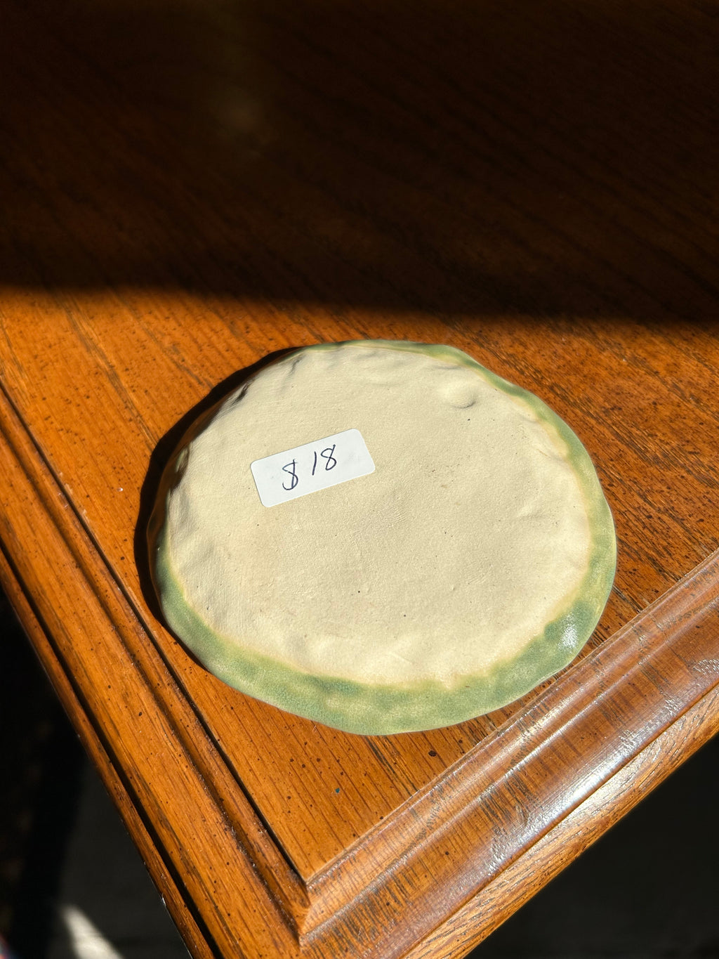 Round stone with a label on a wooden surface