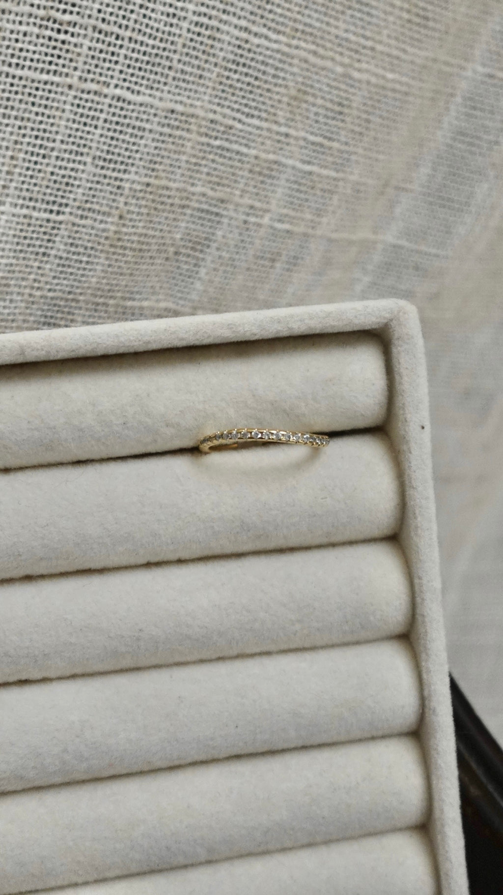 Gold bracelet on a stack of folded white cloths