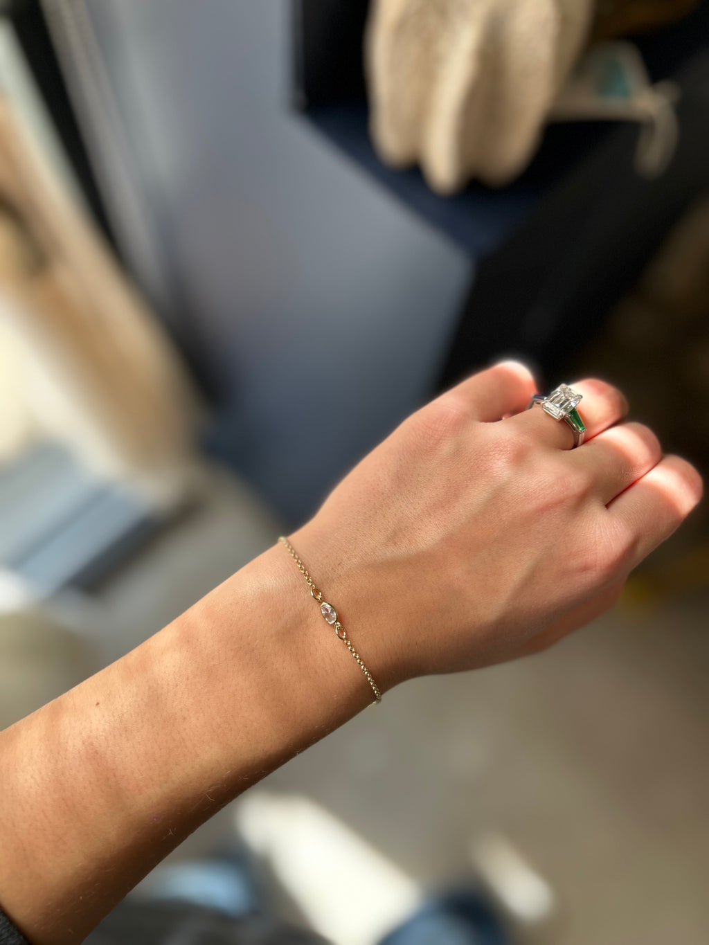 Hand with a ring and bracelet in an indoor setting