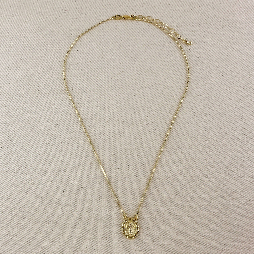 Gold necklace with a pendant on a beige textured background