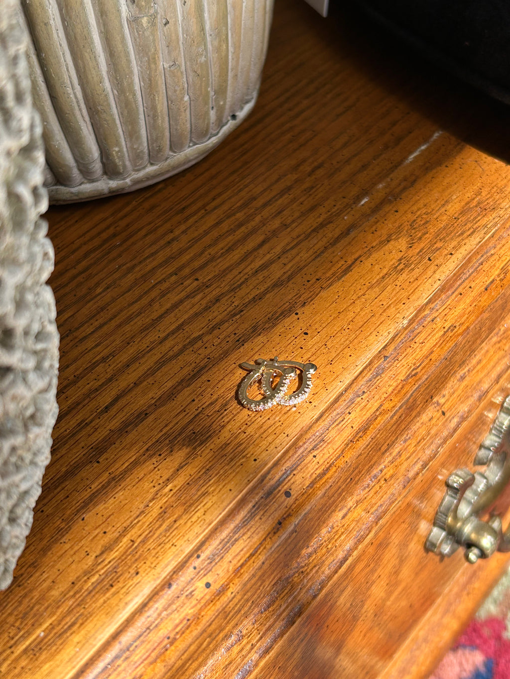 Wooden surface with a metal lock and a textured object in the foreground.