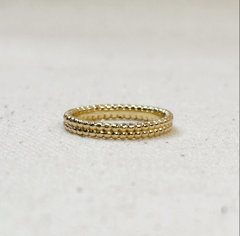 Gold ring on a light gray background