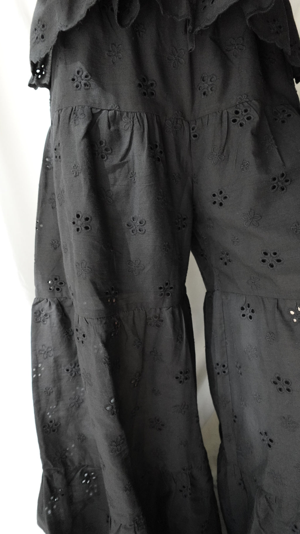 Black fabric with floral patterns on a white background