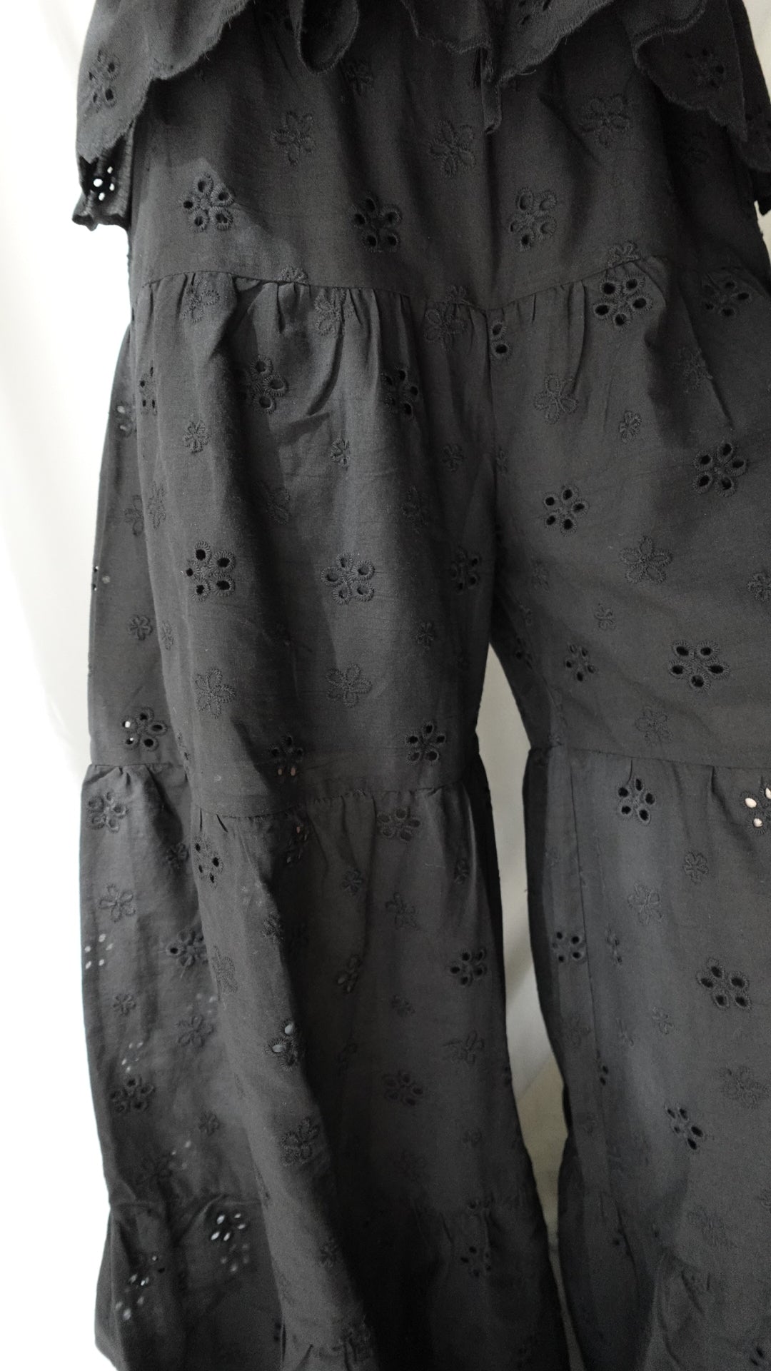 Black fabric with floral patterns on a white background