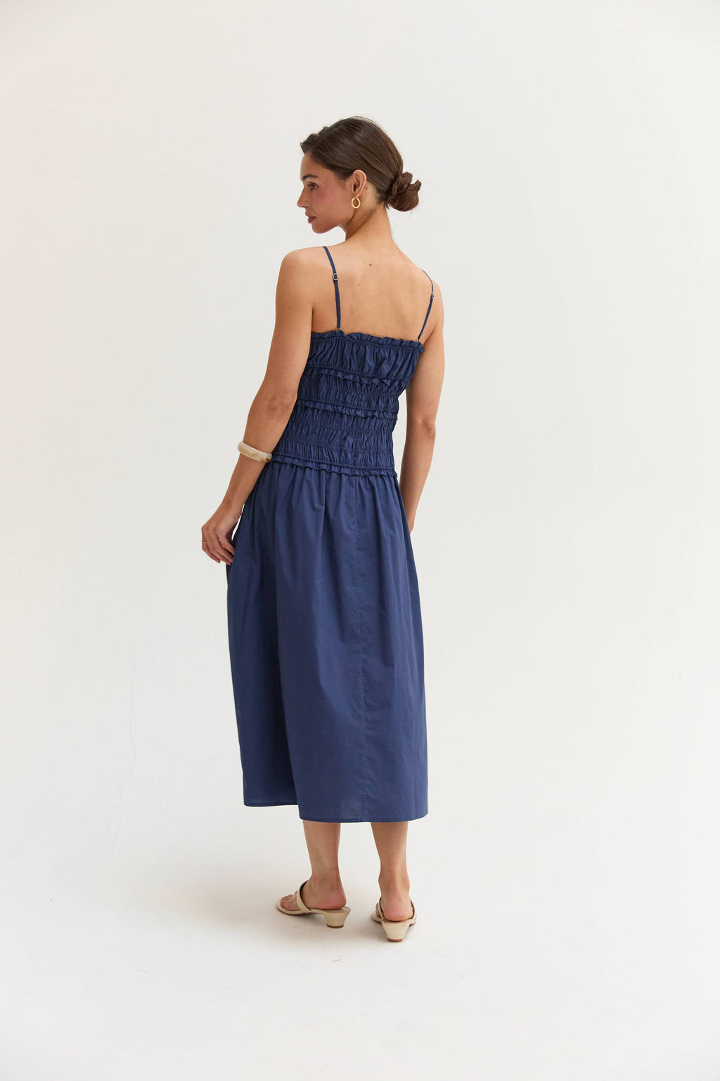 Woman wearing a blue dress on a white background