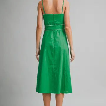 Green dress worn by a model on a gray background