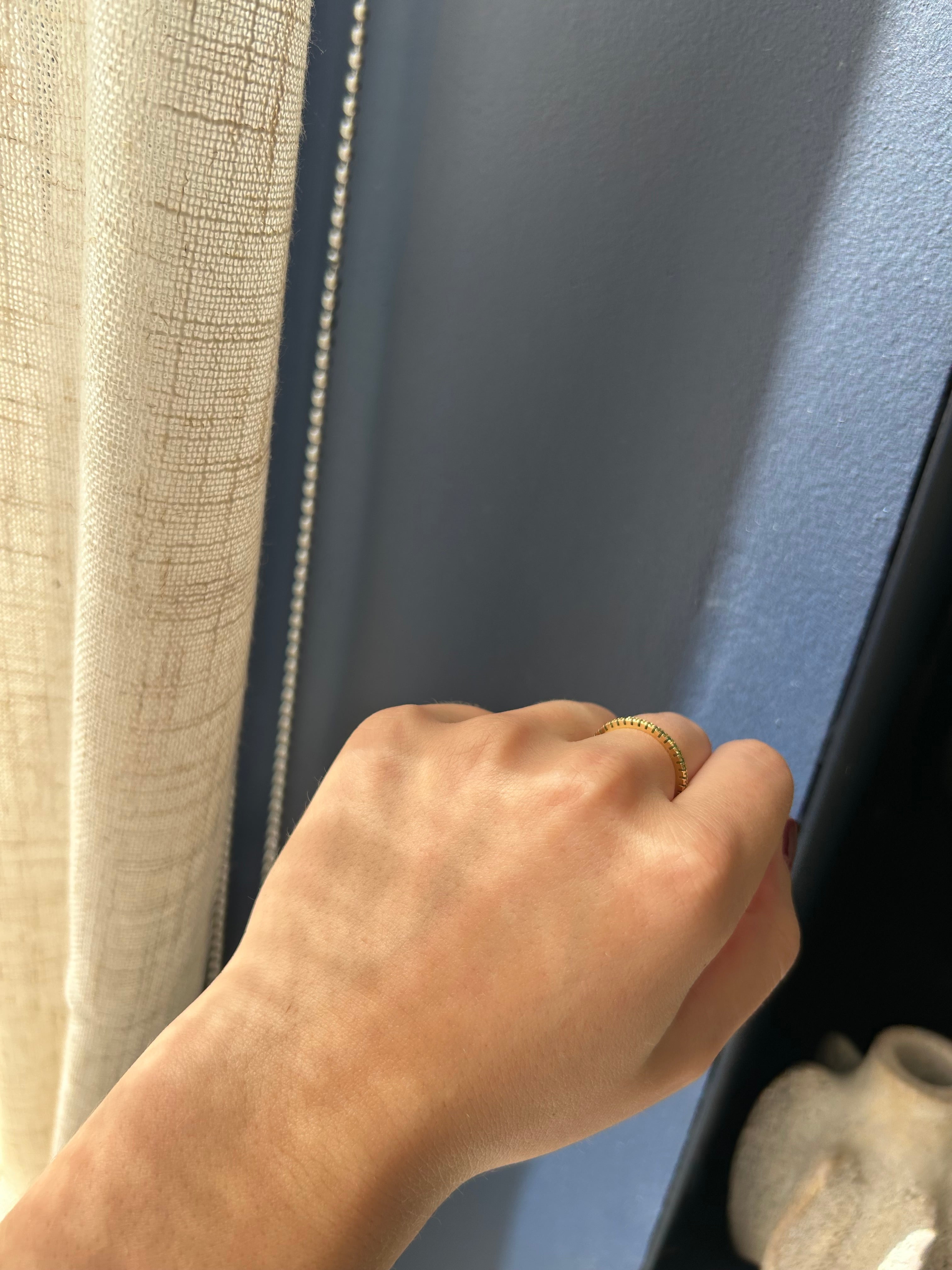 Hand with a gold ring opening a car door