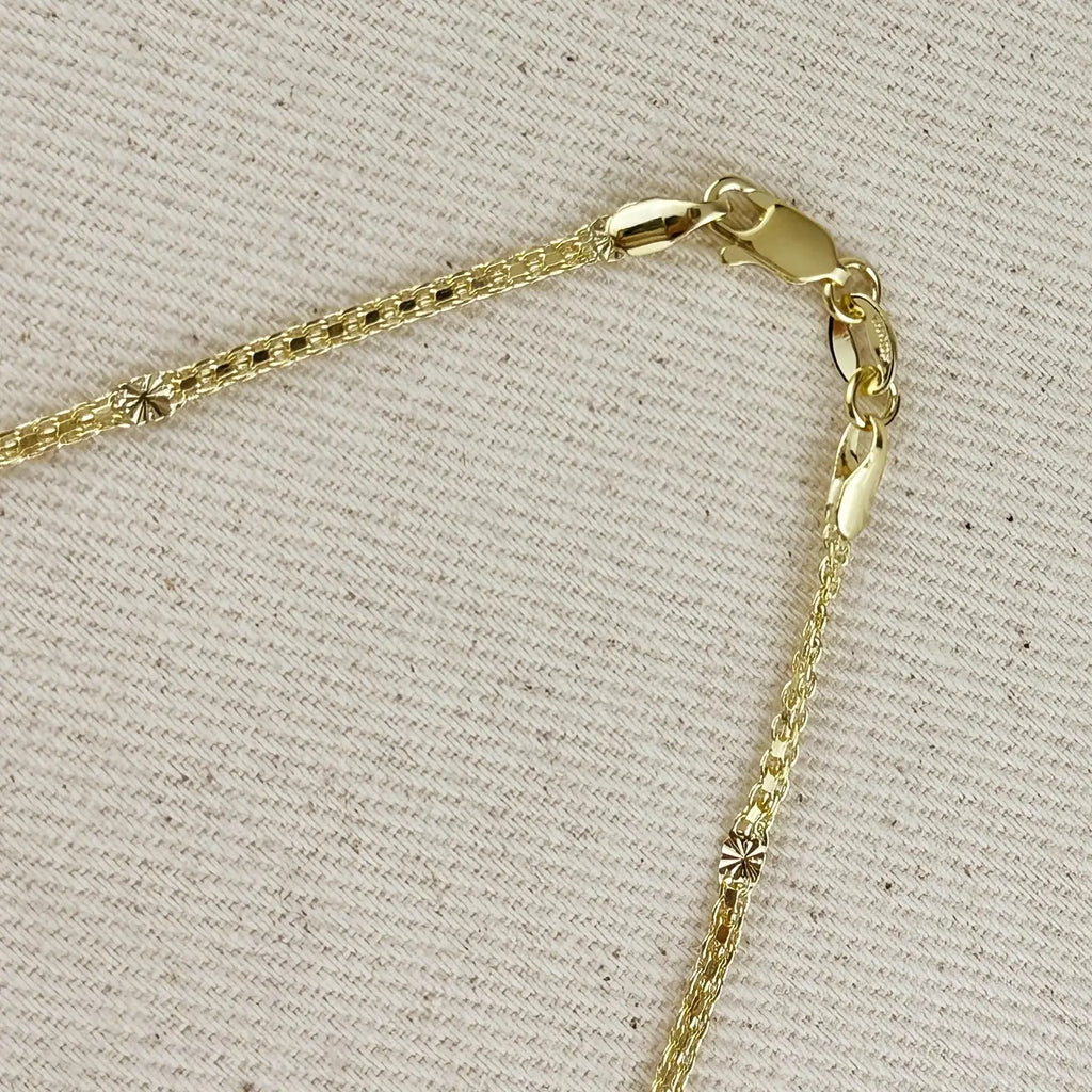 Close-up of a gold chain necklace on a textured beige background