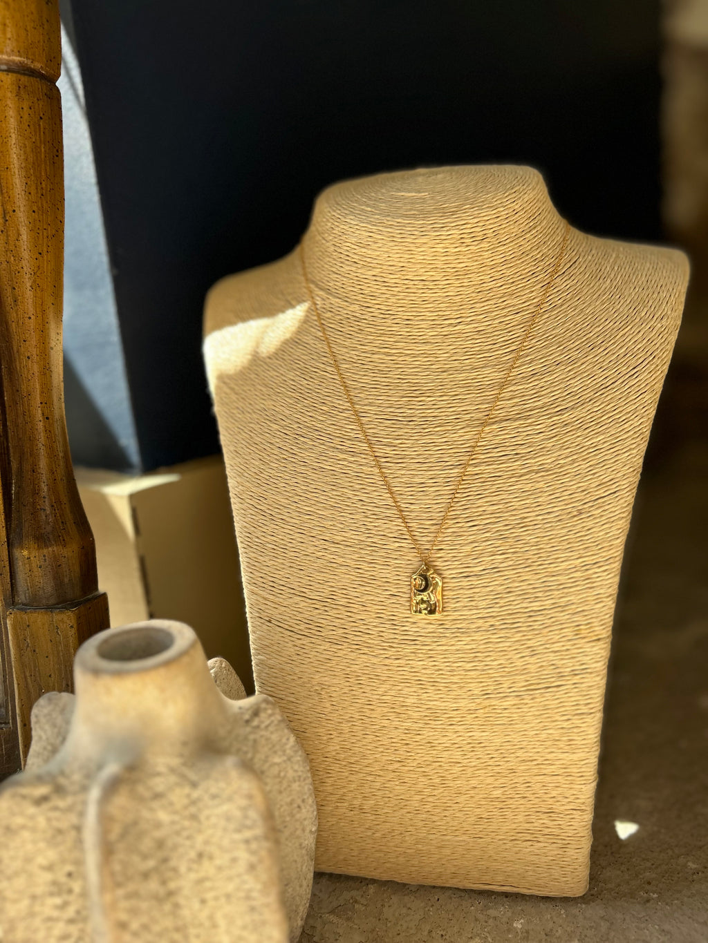 Necklace on a beige mannequin bust with a blurred background