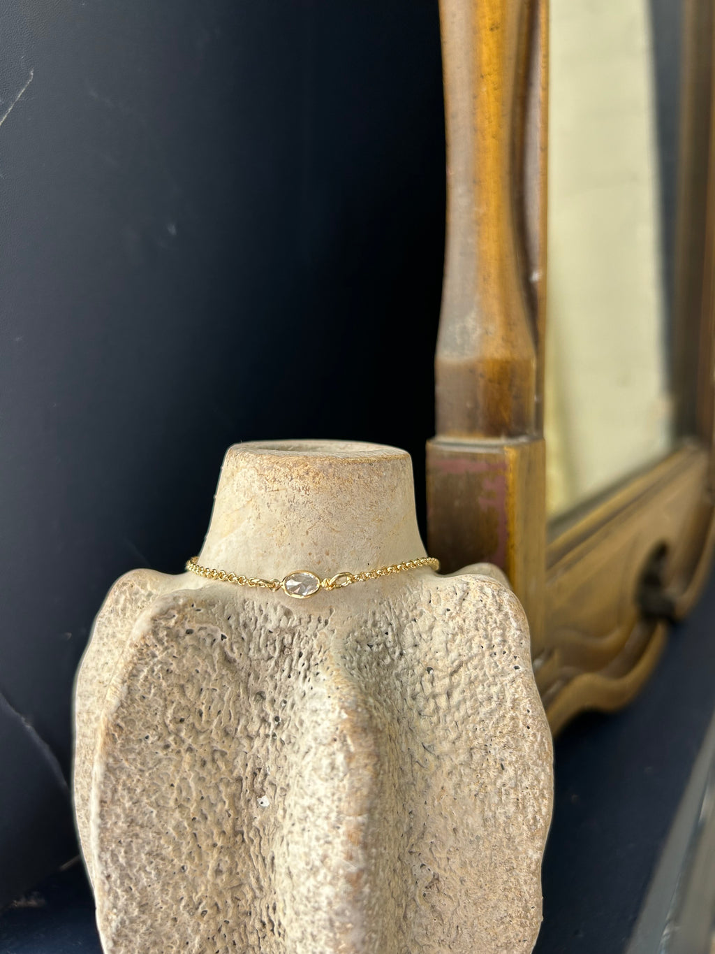 Gold chain on a textured surface with a dark background