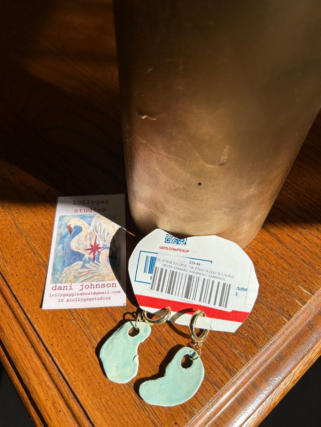 Close-up of a bottle with a label and keychain on a wooden surface