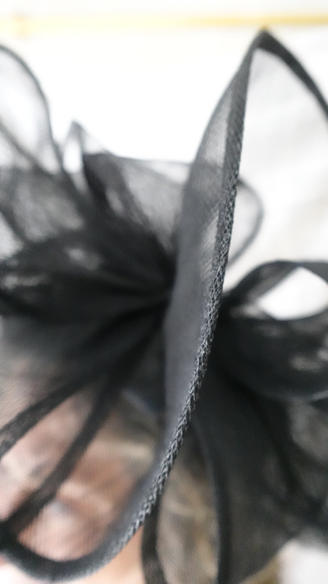 Close-up of a black lace fabric with a blurred background
