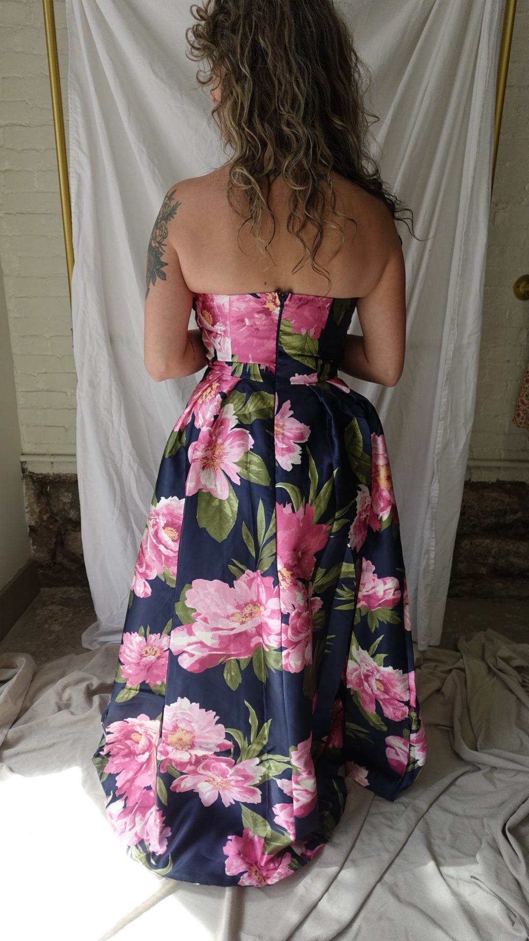 Person wearing a floral dress on a white background