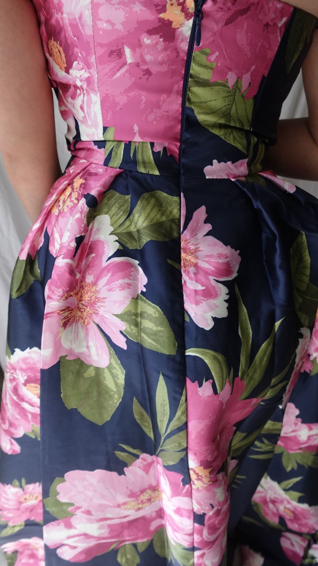 Floral patterned fabric with pink and green flowers on a blue background