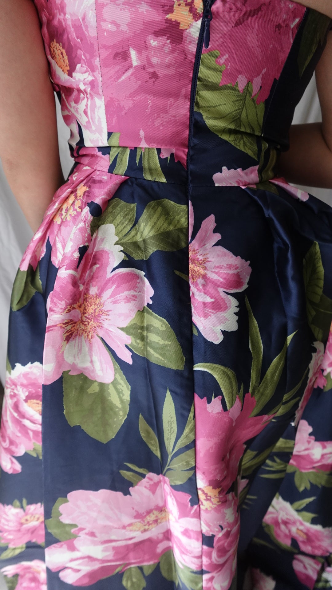 Floral patterned fabric with pink and green flowers on a blue background