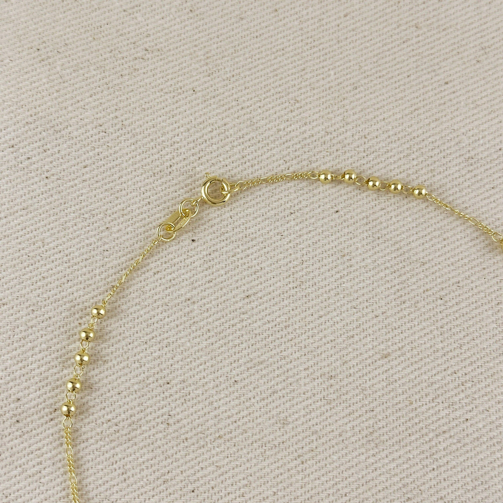 Gold bracelet on a beige fabric background