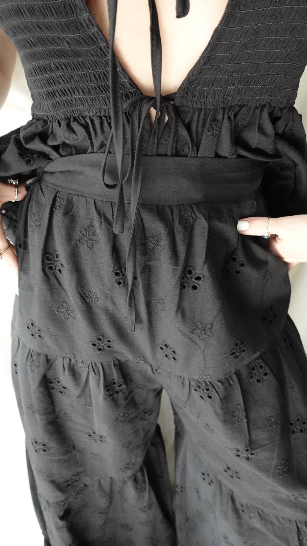 Black dress with floral embroidery held by a person