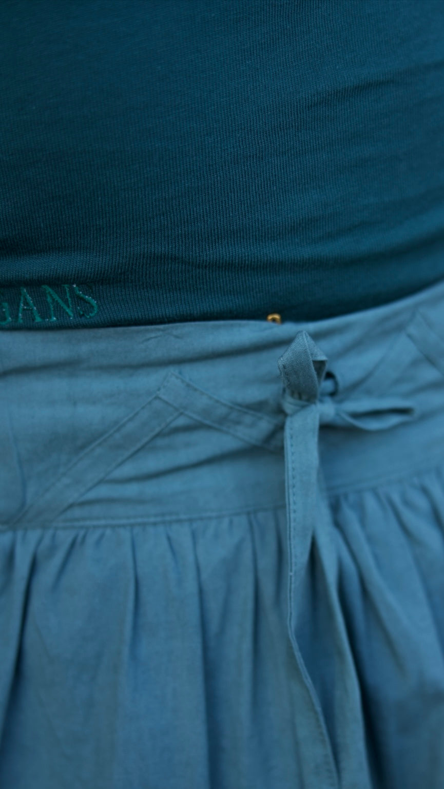 Close-up of a blue garment with a brand name on a dark background