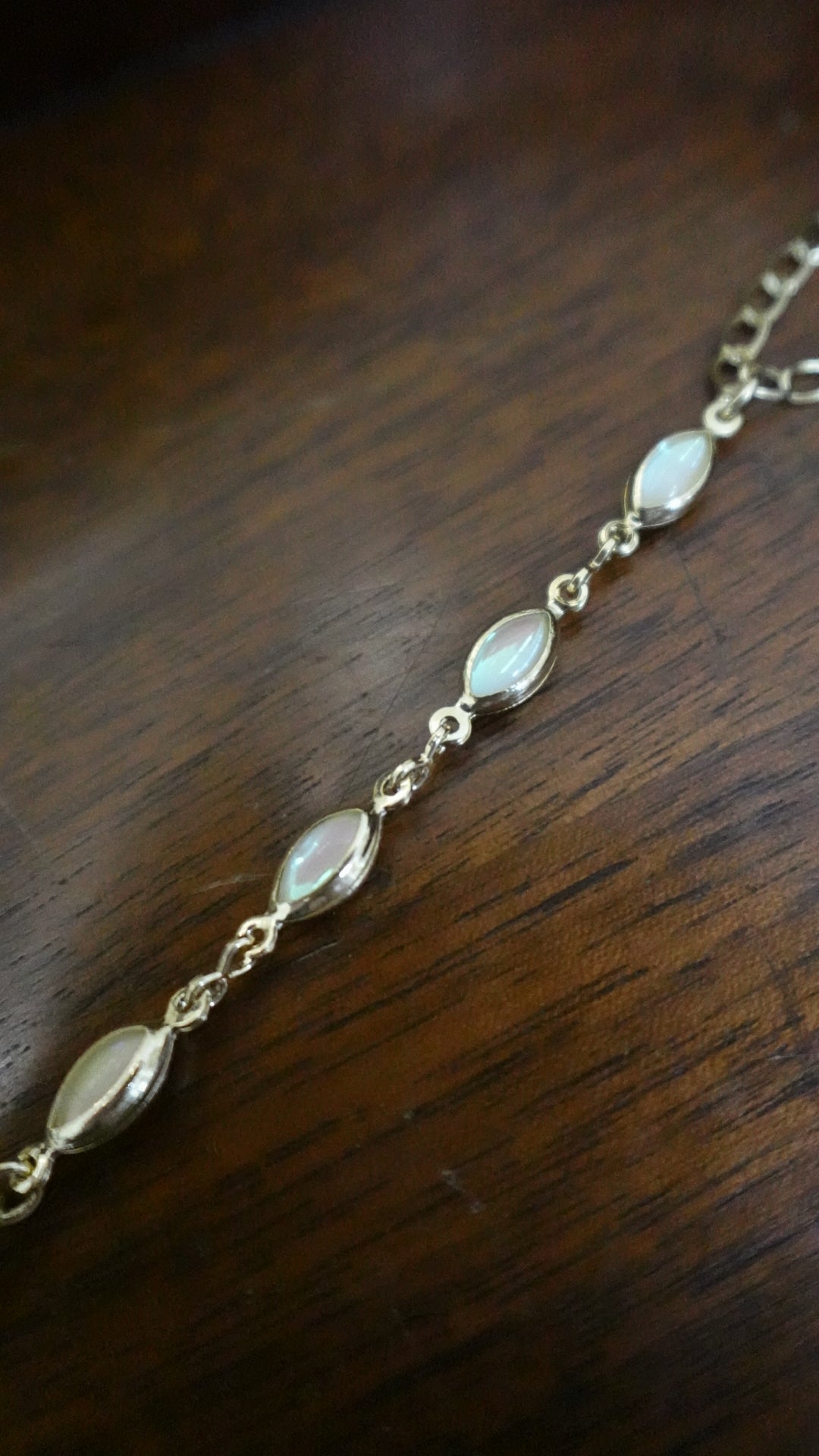 Necklace with white beads on a wooden surface