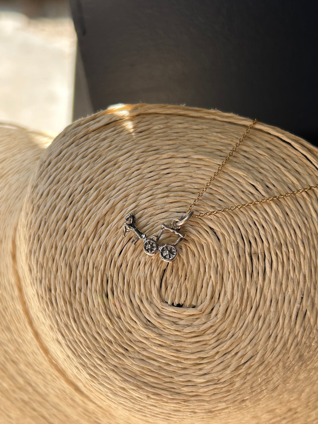 Close-up of a roll of beige twine with a key-shaped charm.