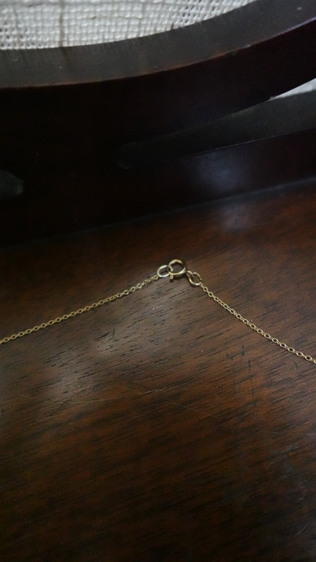 Gold chain on a wooden surface