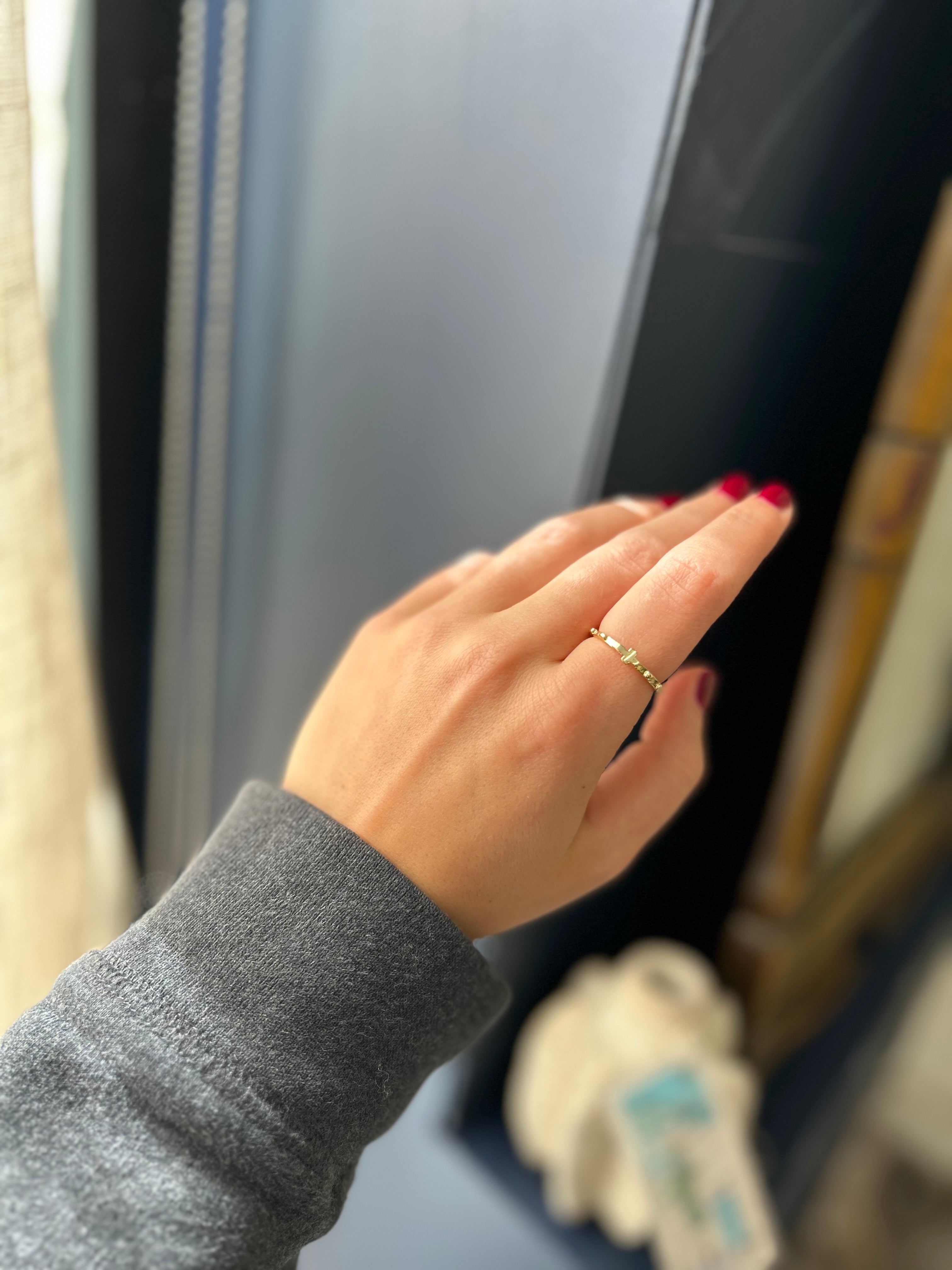 Hand with a gold ring on a blurred background