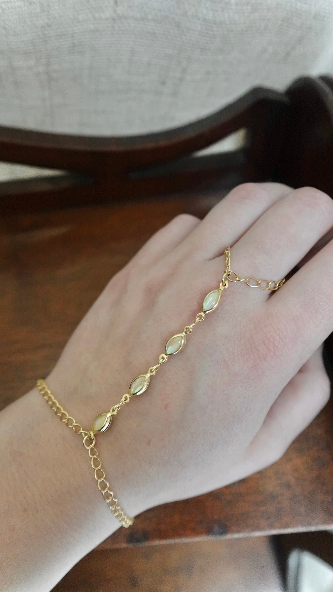 Gold bracelet on a hand with a blurred background