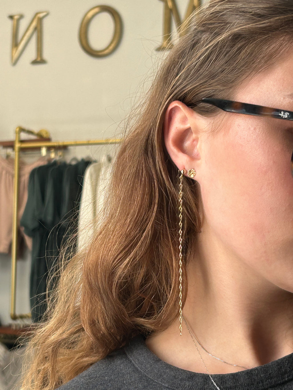 Close-up of an ear with a gold earring, blurred background