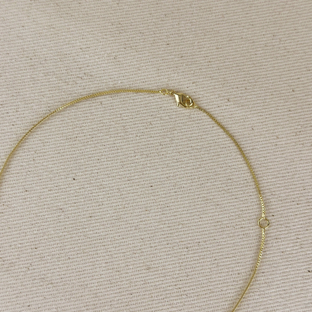 Gold necklace on a beige textured background