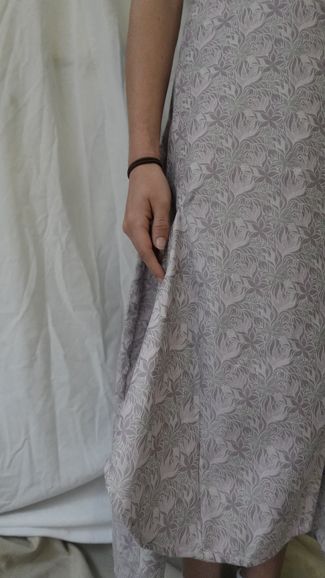 Person holding a textured gray fabric sample