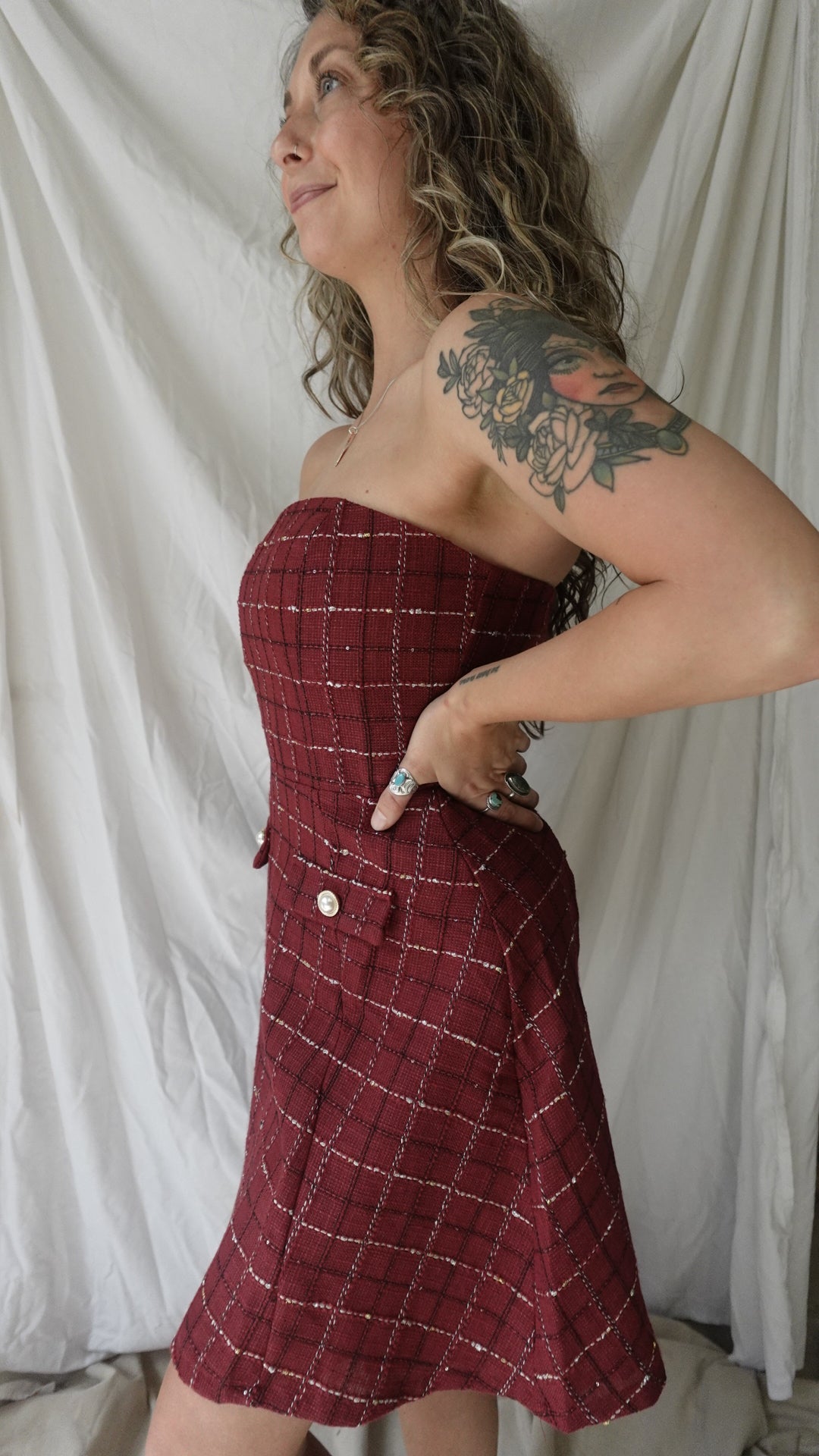 Person wearing a red plaid dress on a white background