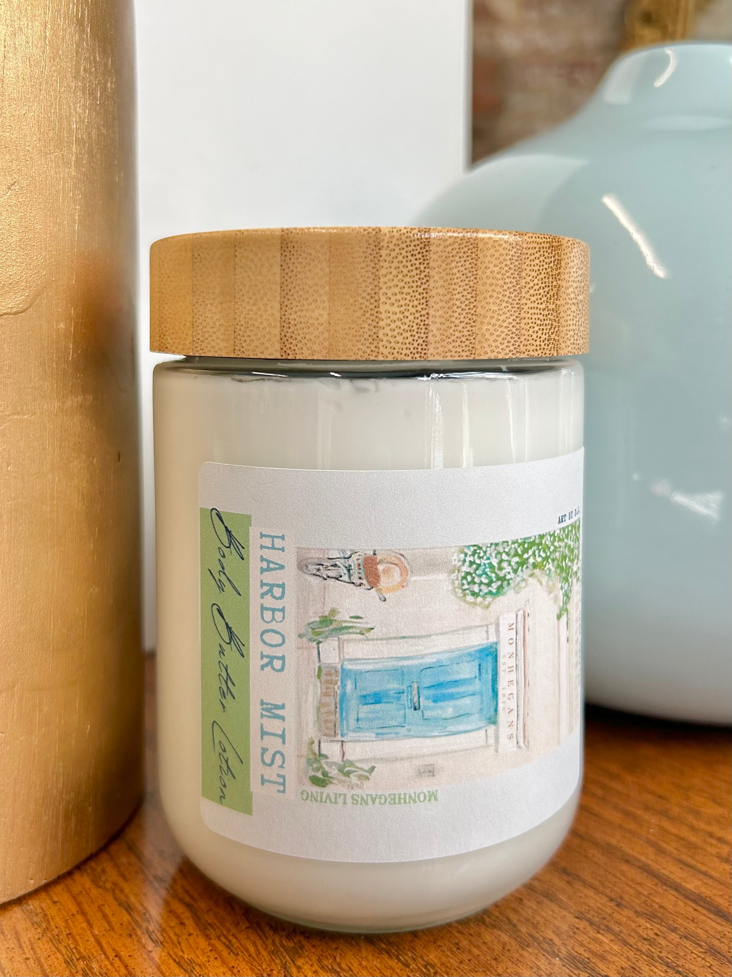 Jar of 'Harbor Mist' candle with a wooden lid on a wooden surface