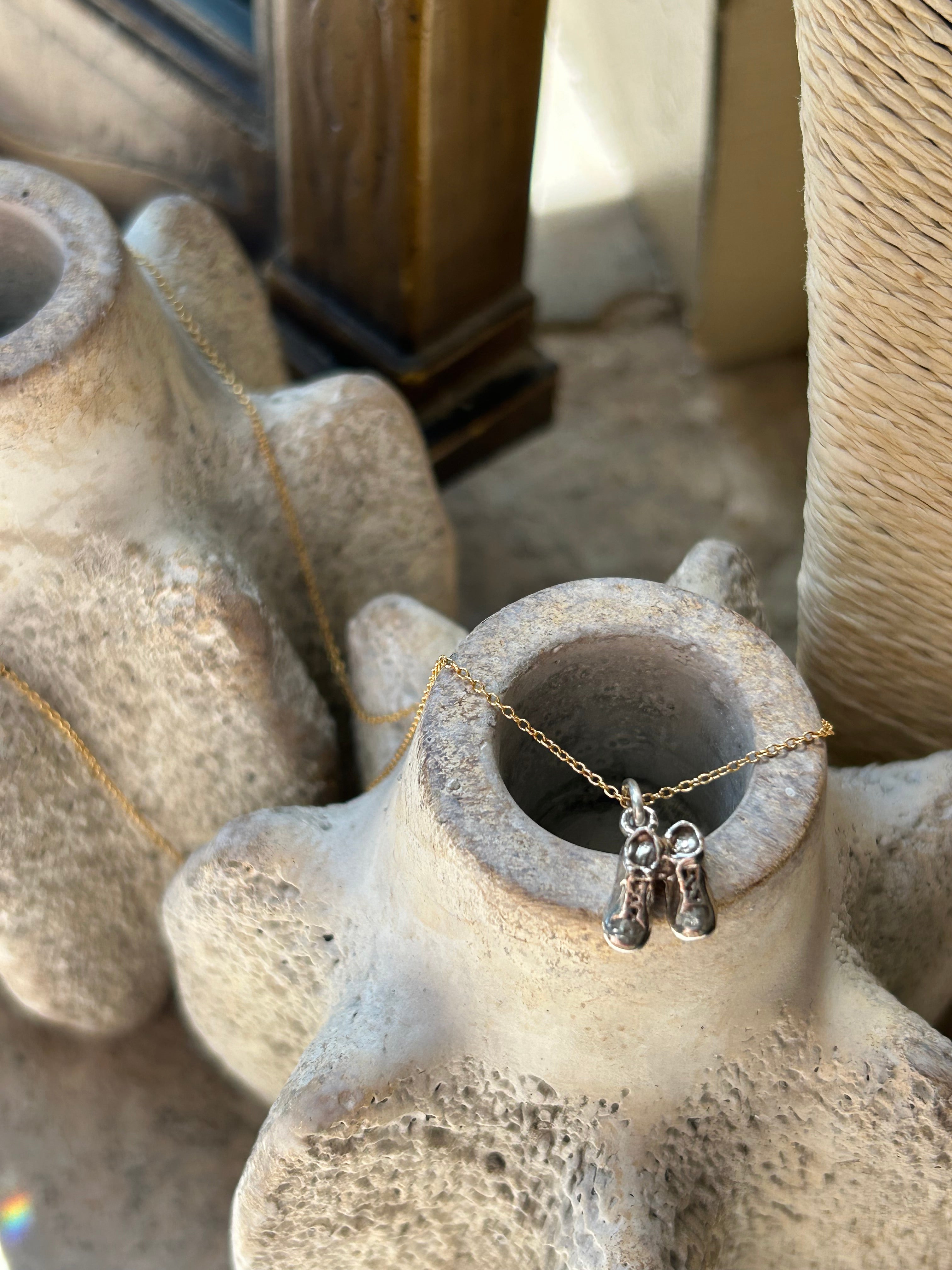 Necklace draped over a textured stone surface