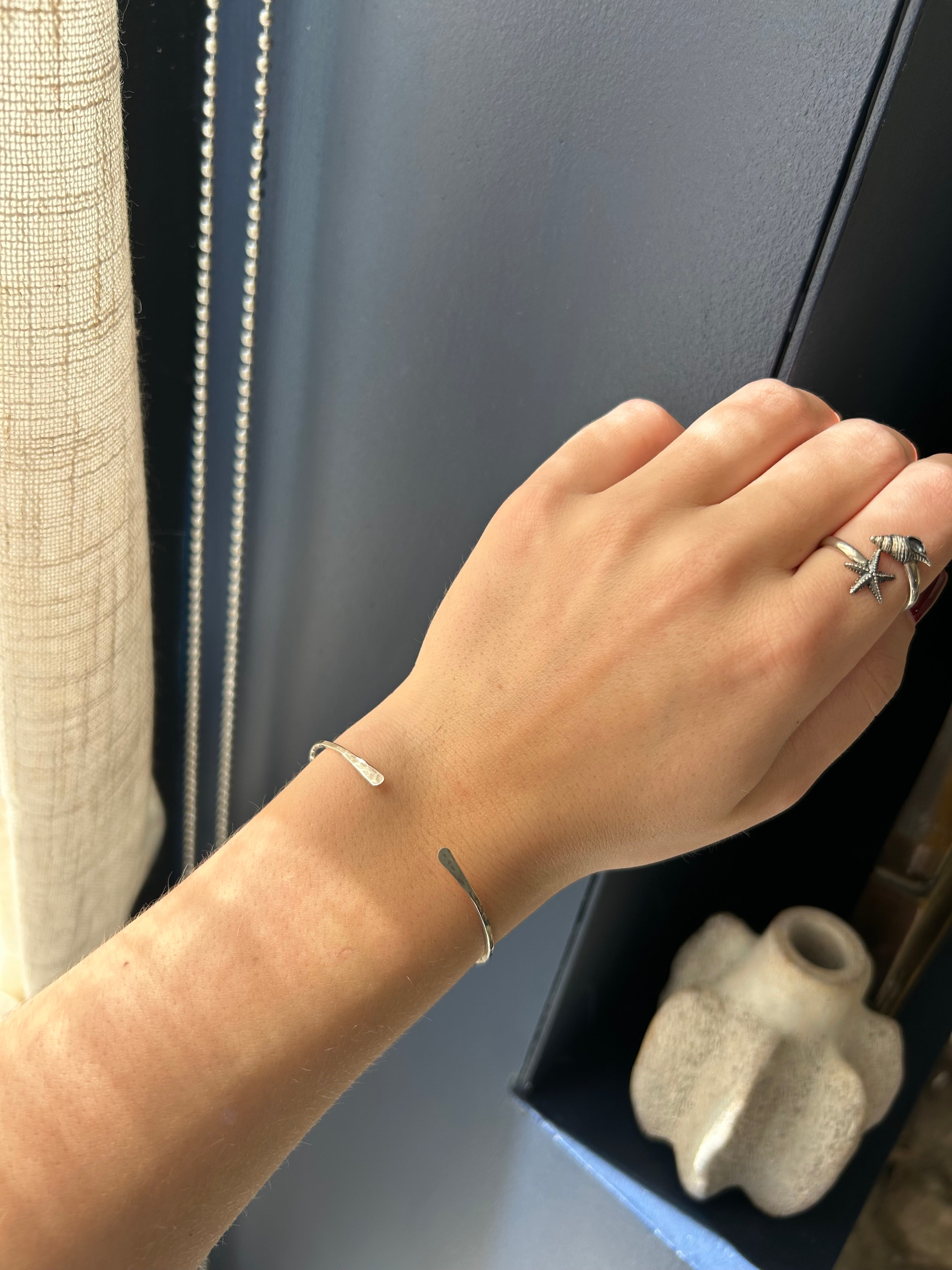 Hand with a ring on a surface with a blurred background