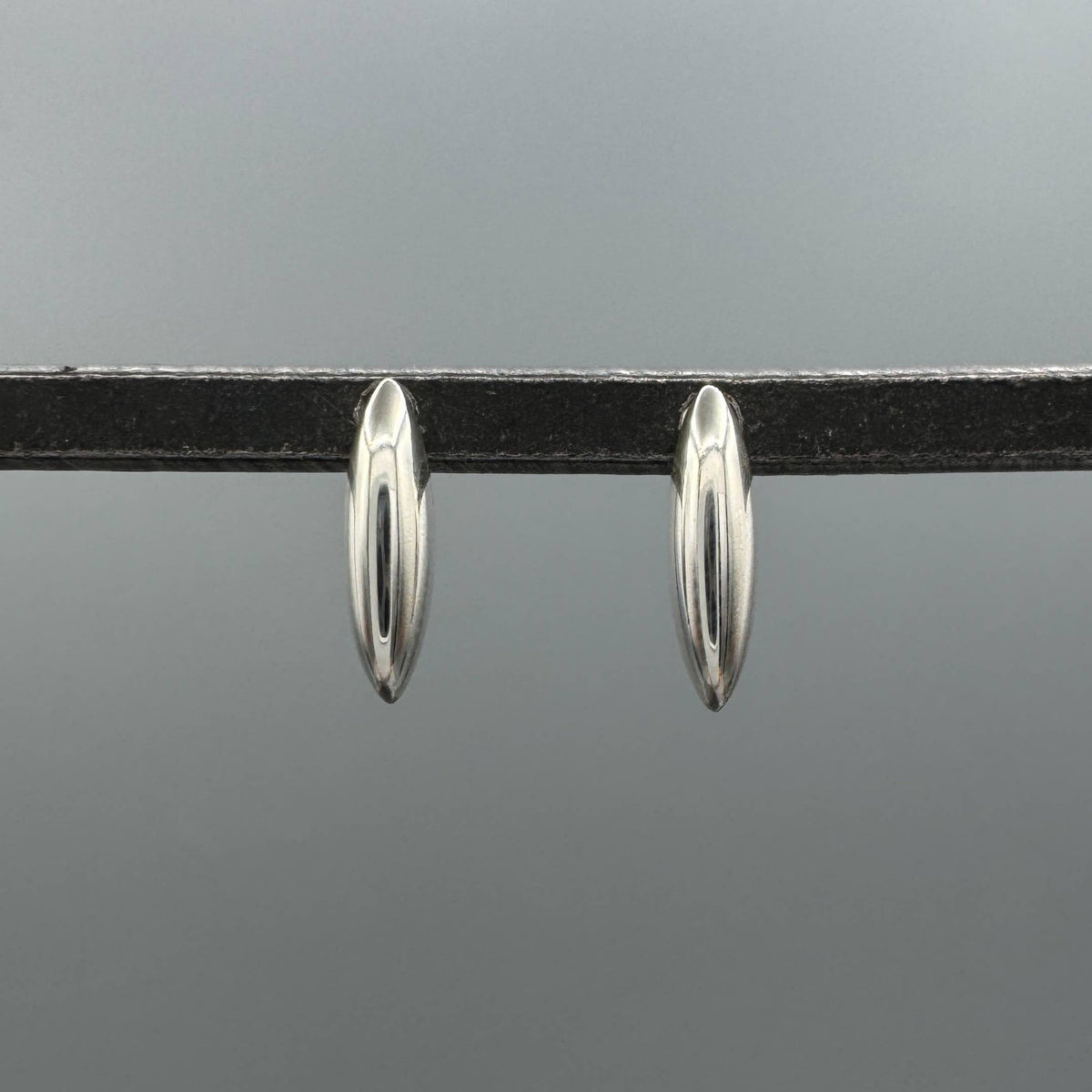 sterling silver dome studs, silver dome earrings, unique silver studs, modern silver earrings, sculptural earrings, marquise stud earrings, elongated marquise studs, elongated stud earrings, silver statement studs, minimalist silver earrings, sleek silver studs, polished silver earrings, 925 sterling silver studs, sterling silver jewelry, geometric silver earrings, oval dome earrings, curved silver studs, contemporary earrings, modern jewelry, unique stud earrings, everyday silver earrings, silver ear stack