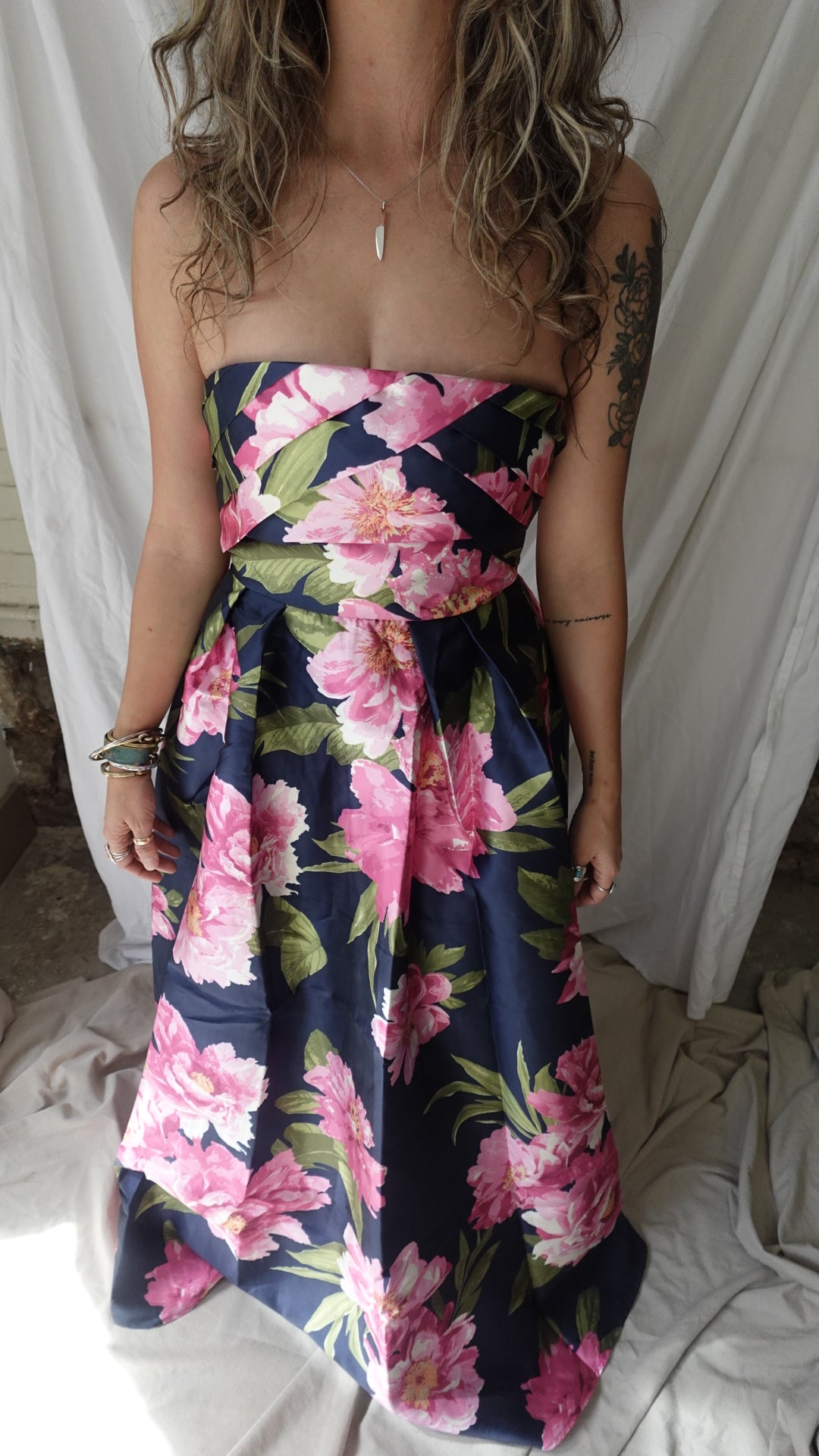 Person wrapped in a floral blanket on a bed