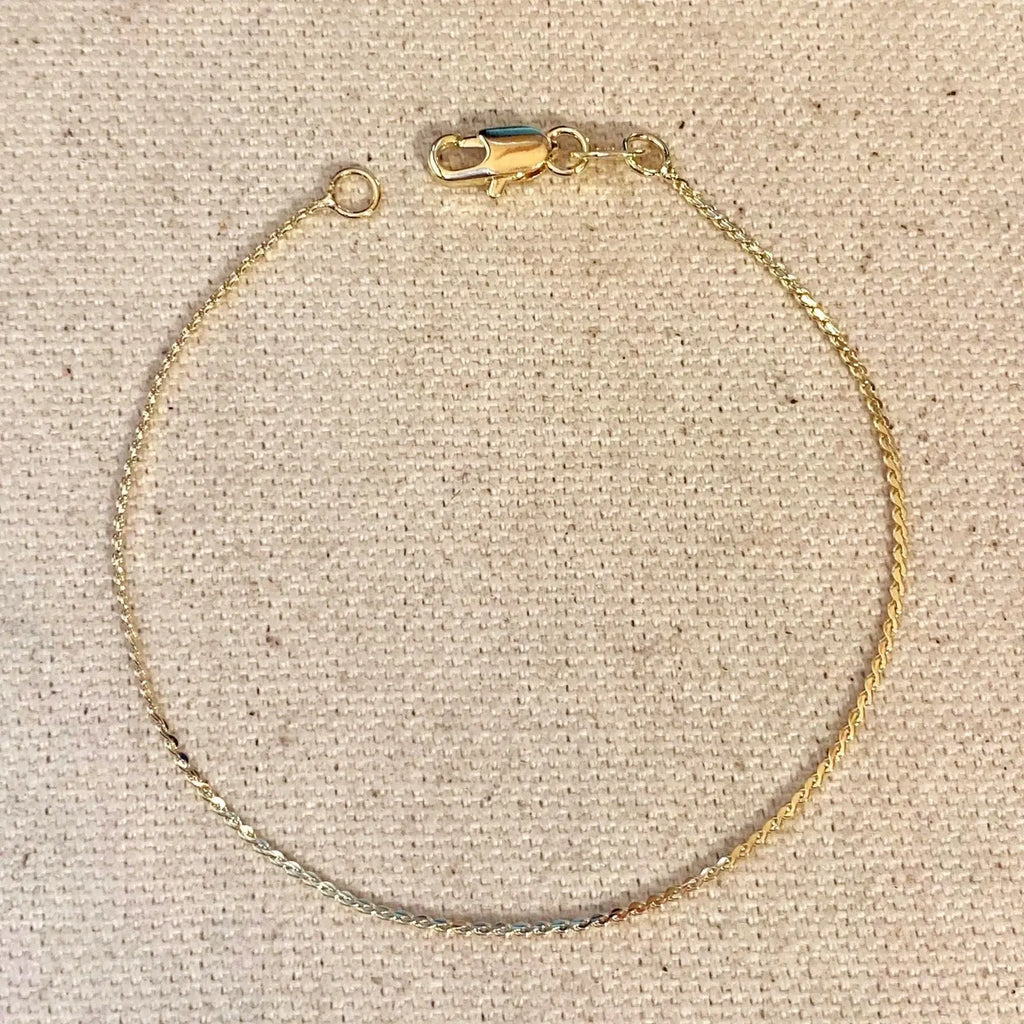 Gold bracelet on a beige fabric background