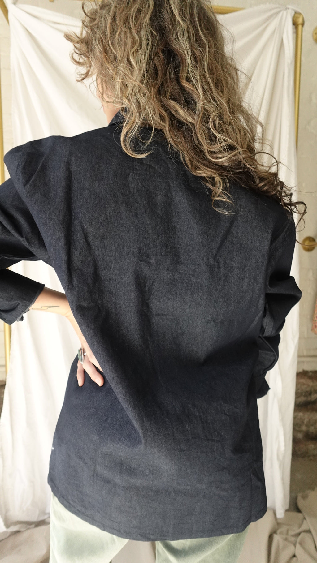 Person wearing a dark blue coat with a blurred background