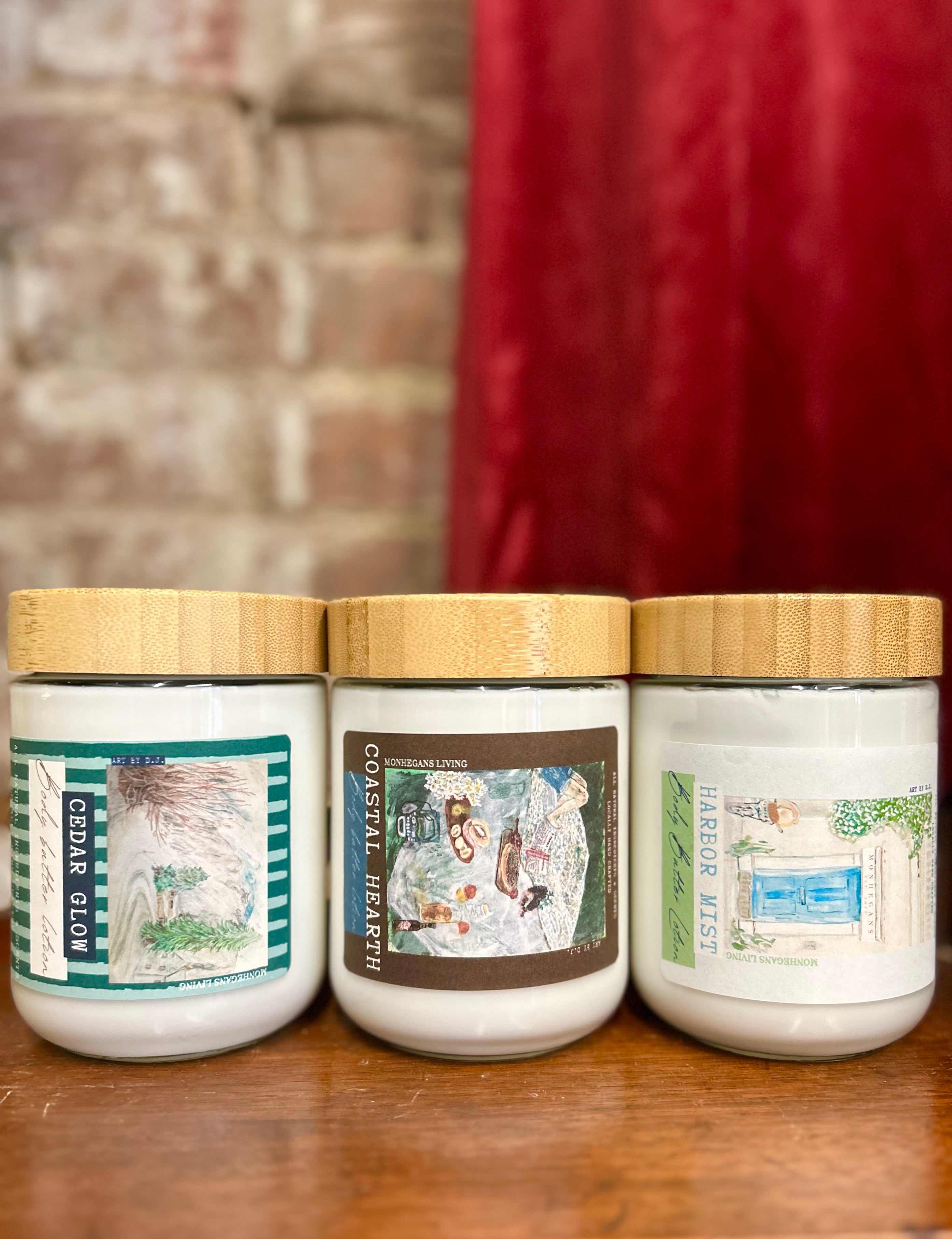 Three lotions with labels on a wooden surface against a brick wall background